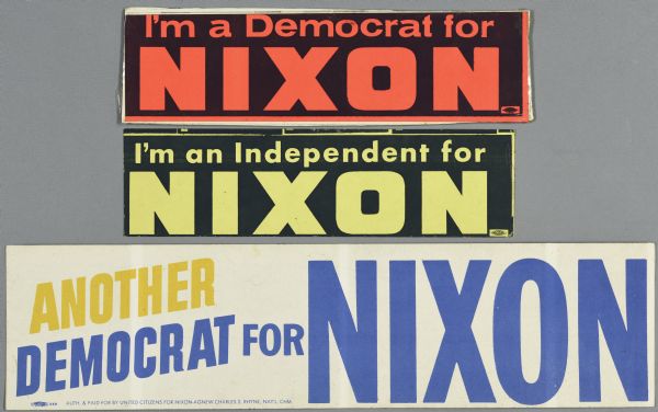 Three bumper stickers supporting Richard Nixon, from non-republican parties. The top bumper sticker is black with orange text and reads: "I'm a Democrat for Nixon." The middle bumpers sticker is black with yellow text and reads: "I'm an Independent for Nixon," and the bottom bumper sticker is white with blue and yellow text and reads: "Another Democrat for Nixon."