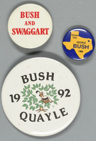 Three presidential political campaign buttons. The button on the top left is white with red text and reads: "Bush and Swaggart." The button at bottom left is white, with an image of a quail sitting in a tree with green leaves, and reads: "Bush 1992 Quayle." The button on the right is blue, with a yellow shape of the state of Texas, and reads: "Texans for George Bush 1988." (George H.W. Bush).
