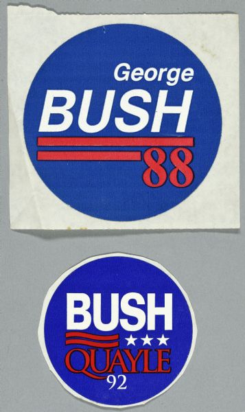 Two presidential political campaign stickers for George H.W. Bush. The top sticker has a blue background and white and red text with red stripes which reads: "George BUSH 88." The bottom sticker has a blue background and red and white text with stars and stripes and reads: "BUSH QUAYLE 92."