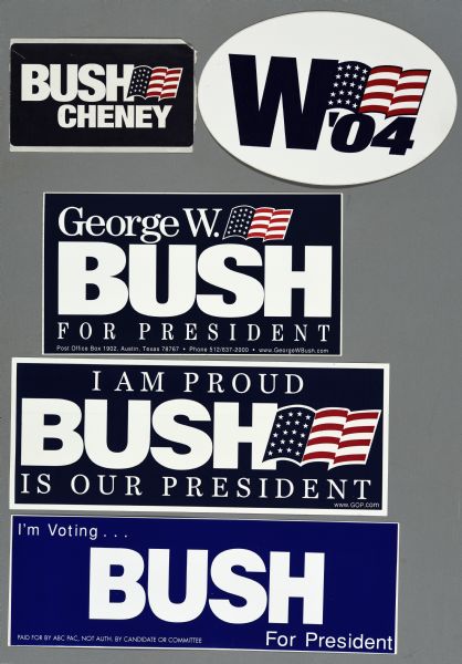 Five presidential political campaign bumper stickers for George W. Bush and Dick Cheney. On the top, one bumper sticker is oval, with a white background, blue text, and an American Flag which reads: "W '04."