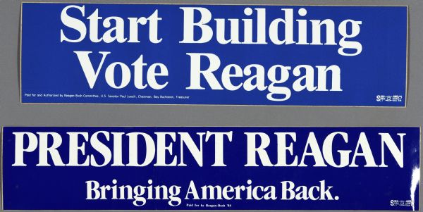 Two blue and white presidential political campaign bumper stickers for Ronald Reagan. The top bumper sticker reads: "Start Building Vote Reagan." The bottom bumper sticker reads: "President Reagan Bringing America Back."