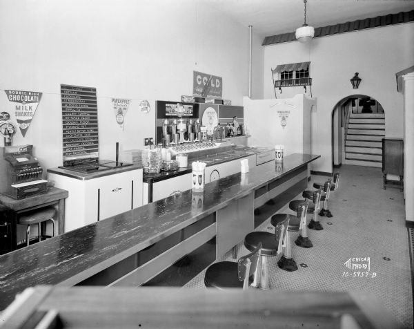 McCoy's Ice Cream Parlor, 507 State Street, showing the soda fountain and bar, taken from the front door. In the back is an arched doorway leading to stairs that lead up to another level.