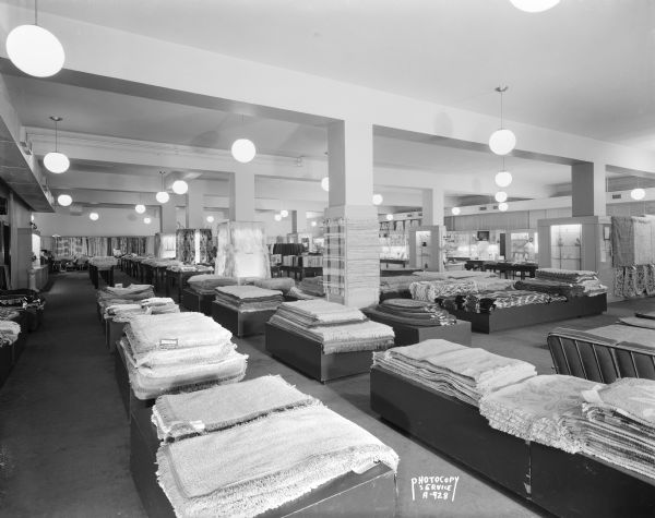 Wide-angle view of floor coverings and rugs on the fourth floor of Manchester's, Inc., department store.