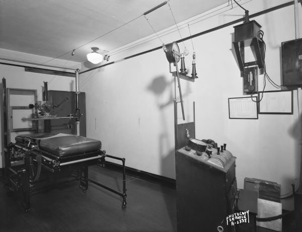 X-ray room in the office of Drs. Arthur and Eugene Sullivan, 617 Gay Building, 16 North Carroll Street, showing the bed and the X-ray machine.