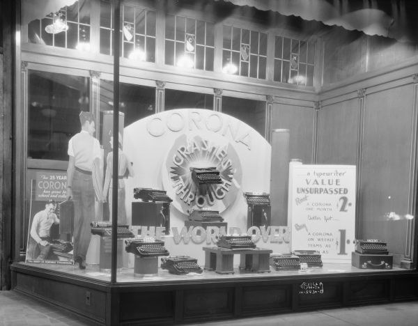 Jones Typewriter Co., 512 State Street, showing Corona typewriter display: "Corona Crashes Through The World Over."