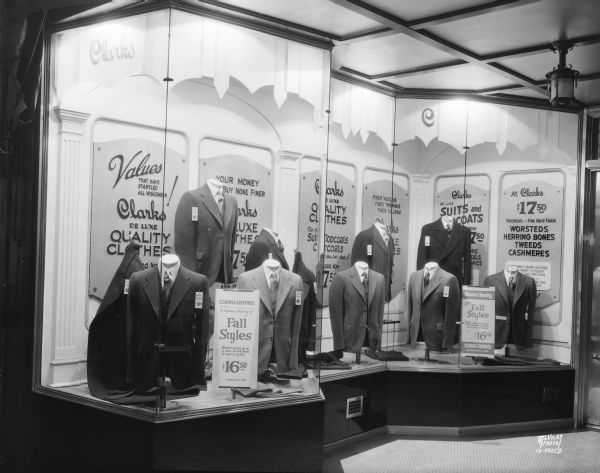 View of window display at Clarks Clothing. 126 State Street, showing the left hand window display of men's suits.