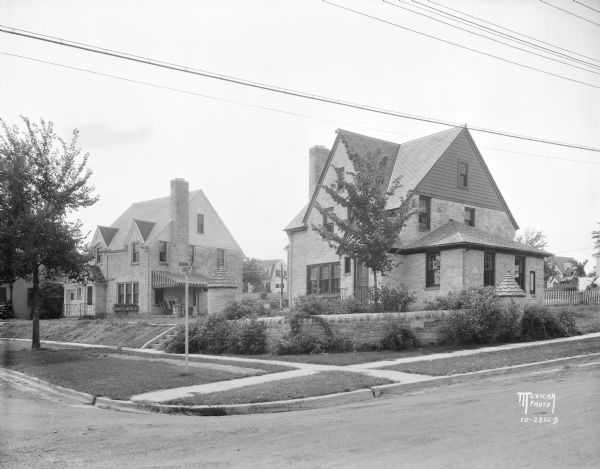 View from intersection with Odana Road towards two Nakoma houses, 702 Seneca Place, and 706 Seneca Place.