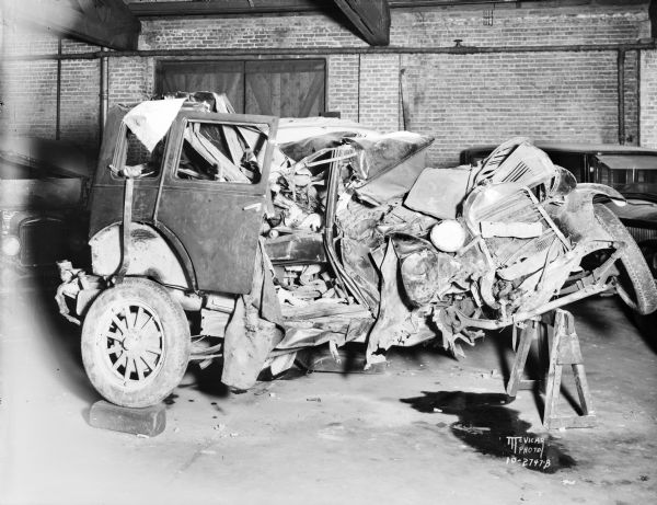 Essex automobile in the repair shop after a crash on July 26 that killed the passengers — Edna Edge (Mrs.Clarence Edge) and Irving "Ole" Brown, WIBA entainer. The accident occurred on the intersection of Highway 51 and Hope Road (aka Buckeye Road), east of Lake Monona. Clarence Edge was arrested for drunk driving and charged with manslaughter on August 22nd, held for trial Sept. 9th and found Not Guilty at his trial in Monroe, WI on Oct. 28, 1931.