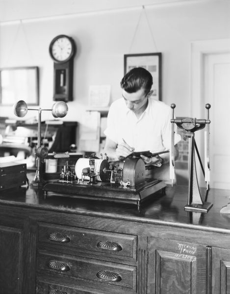 Albert Lorenz, assistant U.S. meteorologist, is reading a wind velocity instrument in the laboratory at North Hall at the University of Wisconsin-Madison.