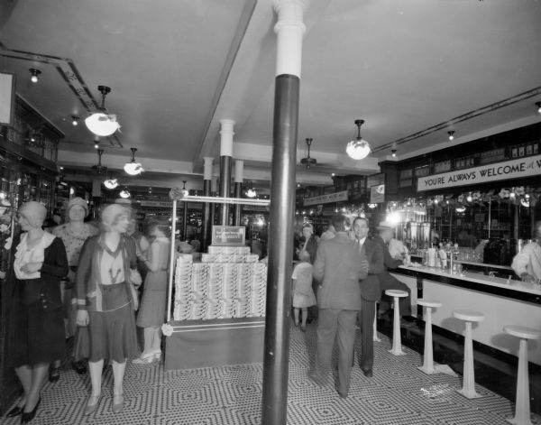 Interior of a Walgreen Drug Store, showing lunch counter and customers, at 30-32 E. Mifflin Street.