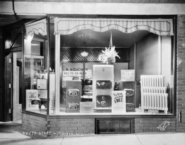 Vecto Store Window at night at 422 W. Gilman Street, at the American Radiator Company. G.N. Boucher, Vecto Dealer.