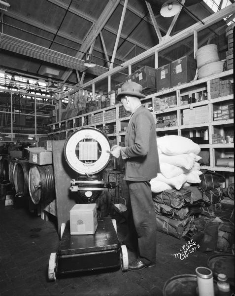 Employee with a Toledo scale at the Fisher Body Co.