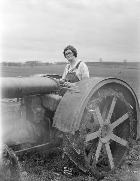 Gertrude (Mrs. Rufus) Gillette driving a tractor, 2627 S. Seminole Highway.