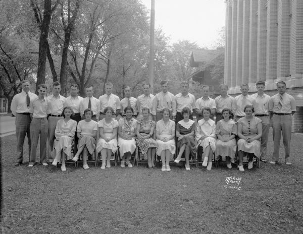 Group portrait of fifteen men and ten women. They are playground supervisors hired by the Board of Education and Madison Park Commission to run nine full time and three half time playgrounds.