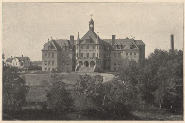 View of the east facade of the three-story brick hospital with its Richardsonian Romanesque arched stone entrance and Roman Catholic cross-topped turrets. The hilltop location on the corner of Western Avenue and S. 23rd Street includes its looped drive, grounds and the power building's chimney towering over a bank of trees on the right. A dwelling, across Western Avenue, is on the left. Opening its doors to the public on September 28, 1899, the new hospital was designed by Manitowoc architect C.H. Tegen. In the late 1890's, Manitowoc was a rapidly growing maritime port city in need of a large, modern medical facility. With encouragement and financial support from city leaders, the sisters of Holy Family Convent, the Franciscan Sisters of Christian Charity, acquired land that had been Gerpheide's Park for the construction of a hospital. With a capacity of 75 beds at its inception, the staff included seven sisters, one lay nurse and three physicians. It was open to all and was a station of the U. S. Marine Hospital Service welcoming seamen of Manitowoc and vicinity. After more than seven decades of service, the building was considered to be inadequate for modern health care needs. It was razed in 1973 with the exception of the first floor, which was given a new roof and provided utility services for the more modern hospital buildings, according to newspaper accounts. The chimney was razed in 2015.