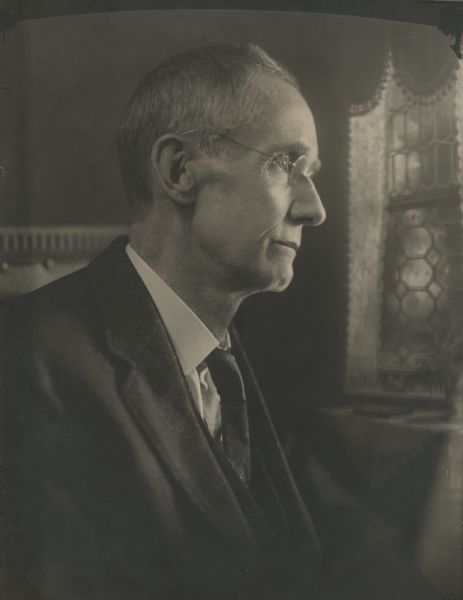 Quarter-length studio portrait of Arthur J. Packard, an early Manitowoc photographer known for views of the area, its people, harbor and marine vessels from about 1880-1910.  A.J. "Jay" Packard (1853-1918) was employed in A.B. Melendy's photography business for several years as a young man. In 1882, the two formed the partnership of Melendy & Packard with a studio at 919 S. 8th St. on the second floor, above the F.C. Buerstatte Drug Store. Melendy left to open a new studio in 1899, while Packard remained at the old location until selling his business to George F. Becker in 1910. In his later years, he assisted in the studio of John A. Glander who had been his young apprentice and to whom he had taught the profession.