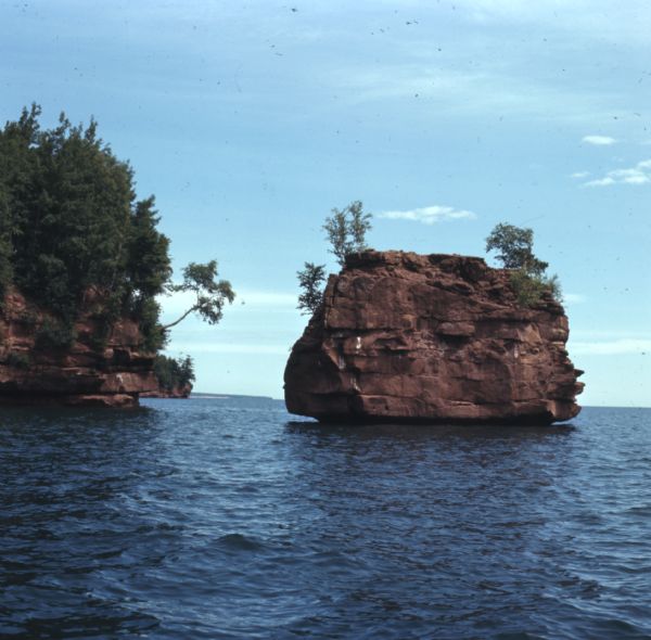 View across water towards two rock formations on the coast of Stockton Islands.