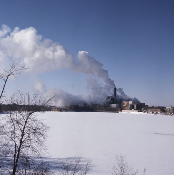 Elevated view across the frozen and snow-covered Wisconsin River towards the Domtar paper and pulp mill.