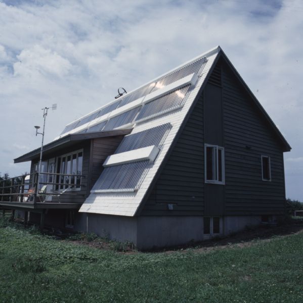View of a home with solar panels on the roof.
