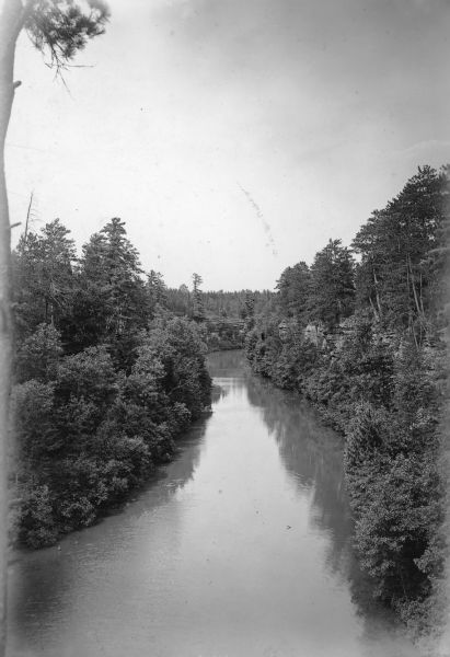 Elevated view of wooded bluffs lining the shoreline of a narrow part of Mirror Lake in this view taken from Ferndale Cliff.