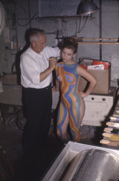 Sid Boyum painting the body of "Abstract Girl." The pattern on her body was based on one of his canvases titled "Traffic." He used Disguise Stix© on the model, the body paint developed by Gene Coffman of Gratco Corporation.
