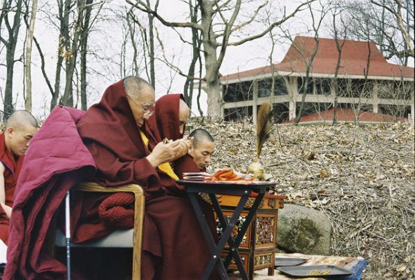 Geshe L Sopa and resident monks blessing the grounds for the new Deer Park Buddhist Center Temple, with the original Kalachakra temple in the background.