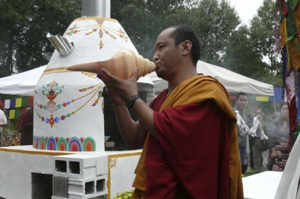 Monk blowing a conch shell at the cremation ceremony of Geshe L Sopa, Deer Park Buddhist Center.