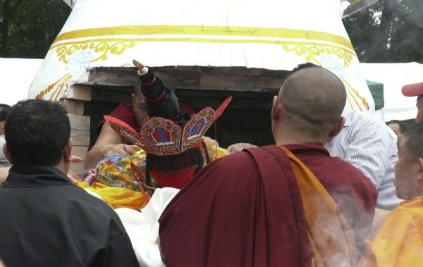 Monks putting Geshe L Sopa's body in the crematorium at the Deer Park Buddhist Center.