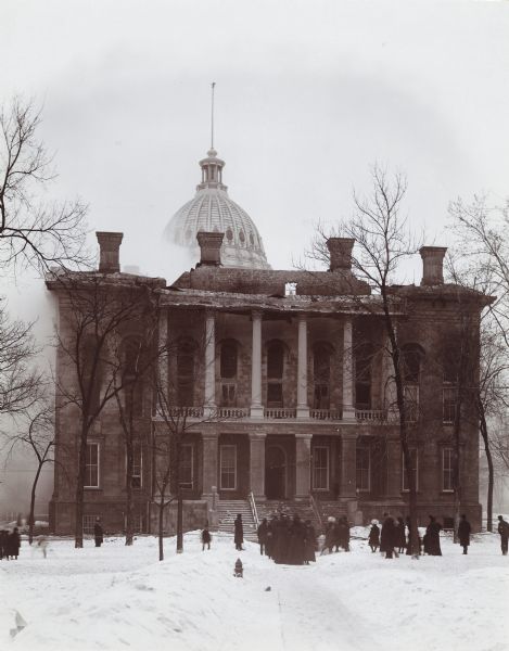 Spectators near the South Wing of the third Wisconsin State Capitol watching the fire that eventually destroyed most of the building.