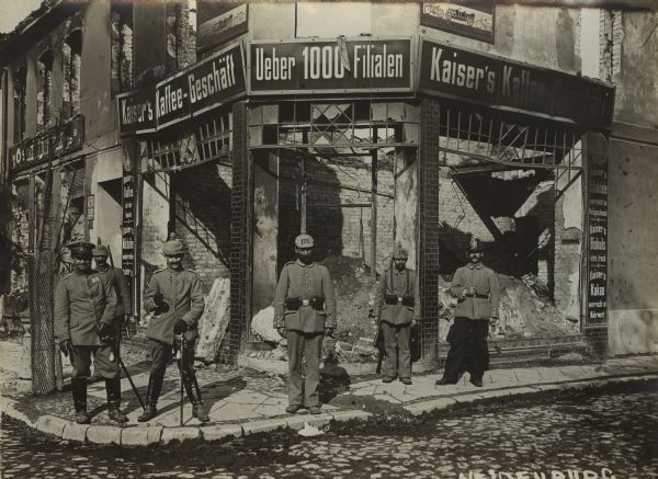 German soldiers posing in front of a destroyed storefront in the city of Neidenburg in East Prussia in September 1914. Taken after the expulsion of Russian forces which had invaded East Prussia in August 1914 and been subsequently defeated at the Battle of Tannenberg.