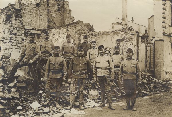 Soldiers posing standing amidst the ruins of destroyed buildings in Sabac, Serbia.