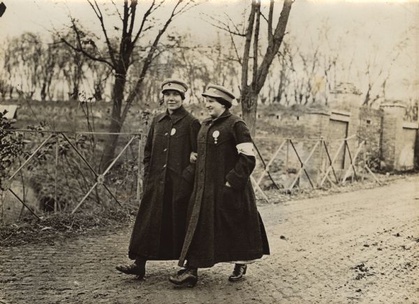 Austrian Red Cross nurses, from Graz, strolling on a road in Syrmien during World War I. 