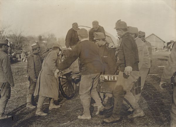 Austrian soldiers are loading ammunition onto a wagon for transport to the front in Serbia during World War I. 