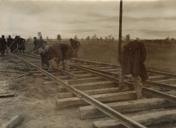 Soldiers repairing railroad tracks. 