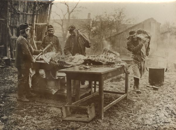 Austrian soldiers slaughtering on a Serbian farm during World War I. 