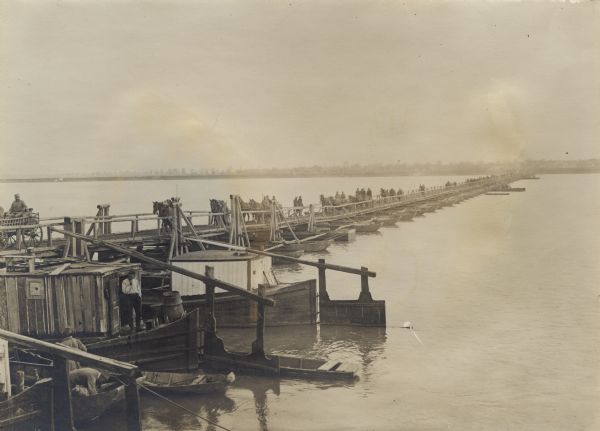 Soldiers crossing the floating war bridge over the Save River during World War I. 
