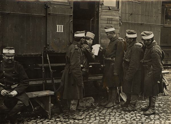 Austrian Railway station guards standing next to a railroad car in the City of Ruma, Syrmien during World War I. 