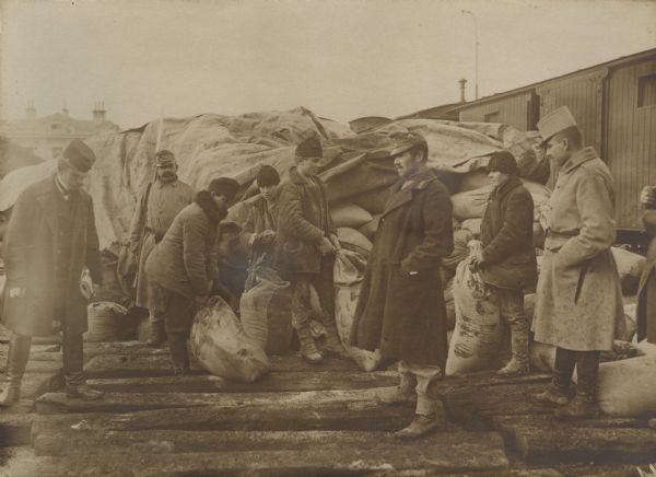 Unloading sacks of flour from train cars for an Austrian divisional field bakery. 