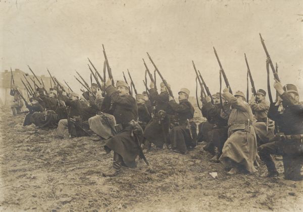 A group of Austrian soldiers are practicing firing at an airplane. 