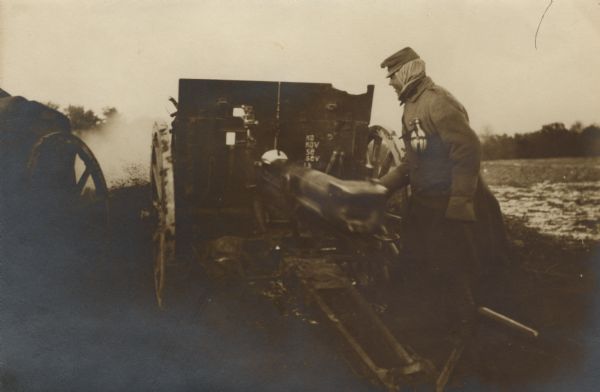 Austrian field artillery piece in Galicia at the moment of firing with the recoil of the firing tube blurred from movement.