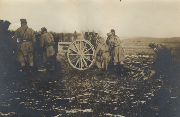 Austrian soldiers preparing a field gun for firing.