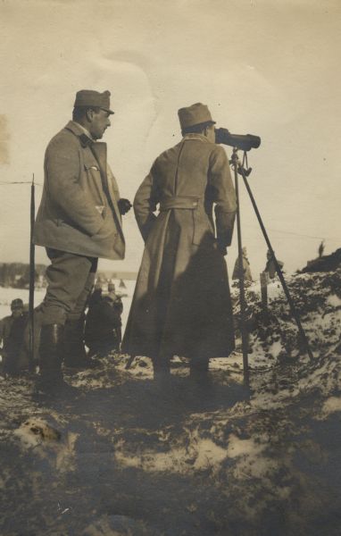 Austrian forward observers in Galicia for a 305mm mortar battery using a field telescope to confirm the firing coordinates.
