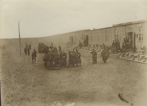 French PoW's in front of a barracks at the camp in Zossen. The front of the barracks building has been decorated by the prisoners.