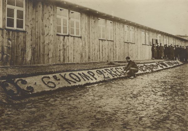 French PoW's beautifying the exterior of a barracks building in the camp at Zossen. 