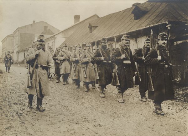 Austrian infantry patrol passing through a village. 