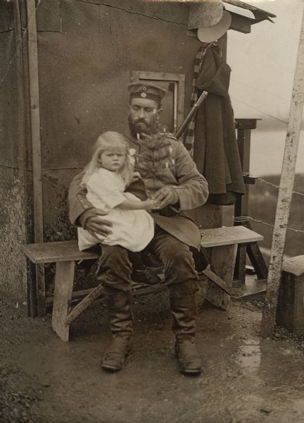 German soldier with young girl and Christmas tree.