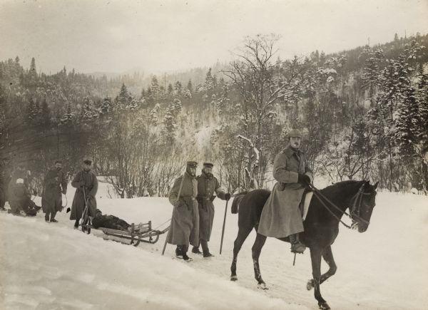German soldiers using sledges to transport Austrian wounded to a first aid station.