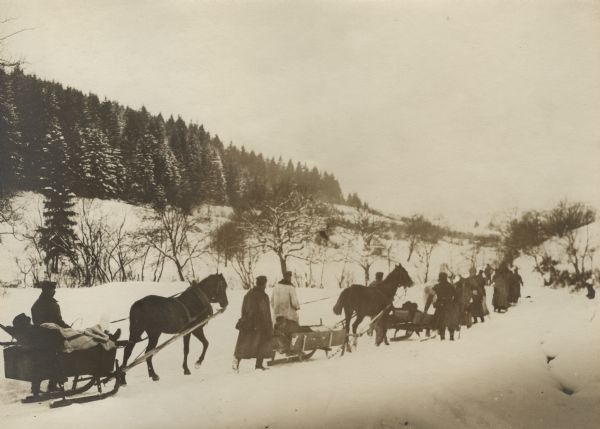 German soldiers using horse-drawn sleighs to transport Austrian wounded to a first aid station.