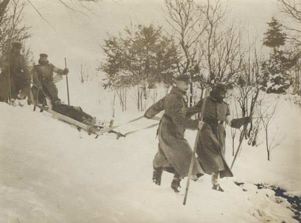 German medics using a sledge to transport Austrian wounded to a first aid station. 