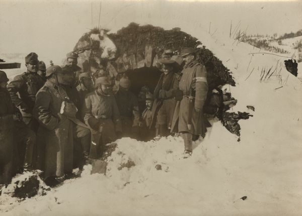 German and Austrian soldiers resting together in a bunker in the snow.